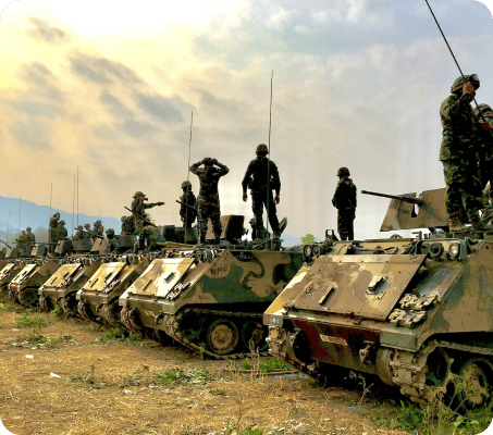 Military men standing in tanks